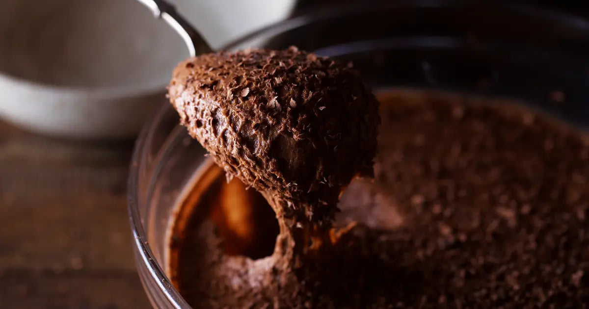 Chocolate brownie batter being mixed in a bowl for edible baking