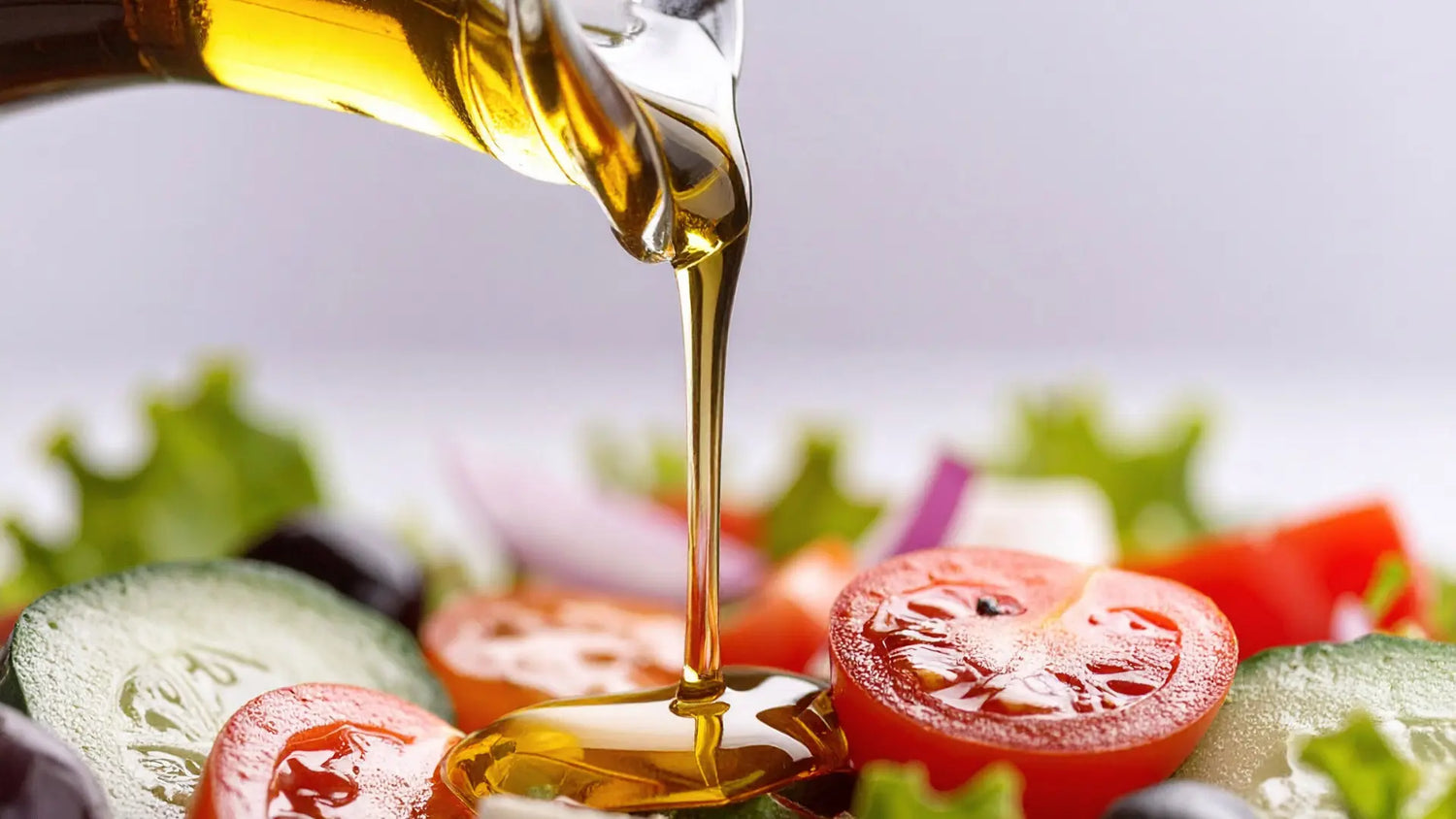 Infused oil drizzled over fresh vegetables and salad ingredients for savory cooking